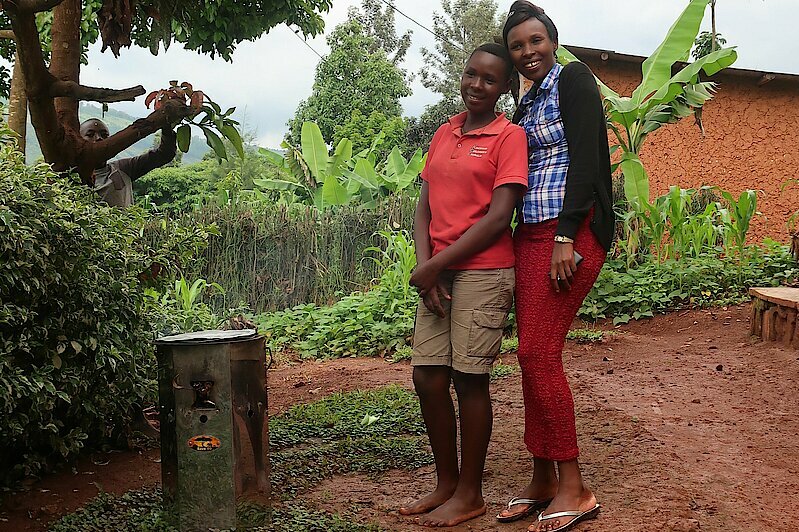 Photo: Two women standing next to each another smiling.