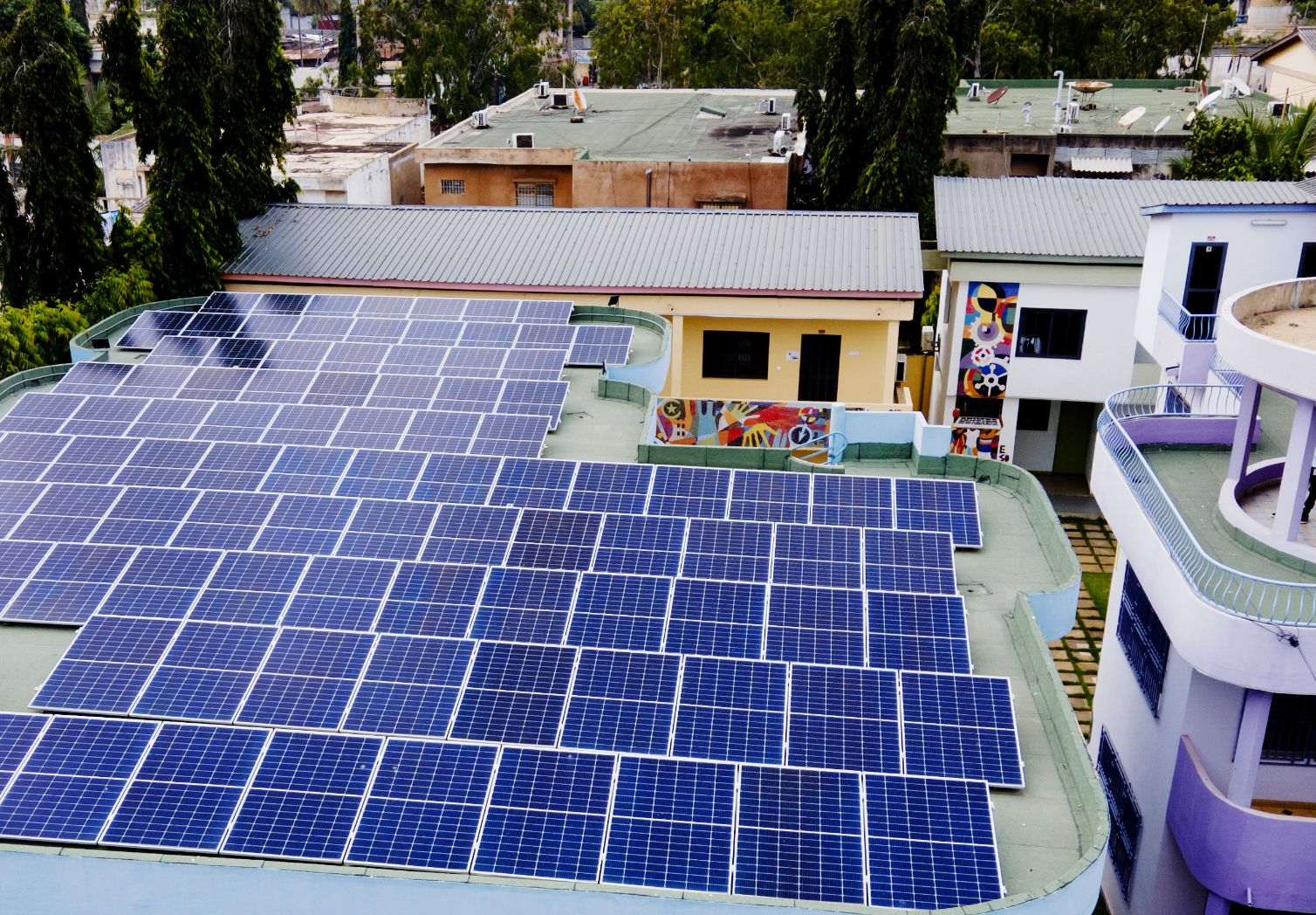 Photo: Photovoltaic system on the flat roof of a building.