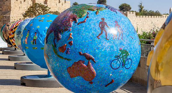 Photo: A row of globes painted in bright colours.