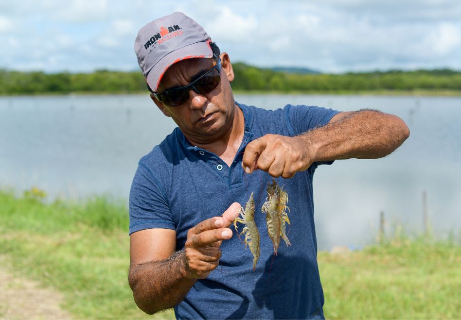 Photo: A man holding fish he has caught.