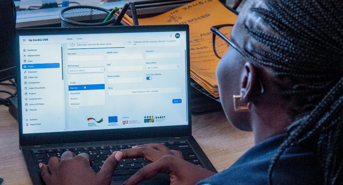 Photo: A woman working on a laptop.