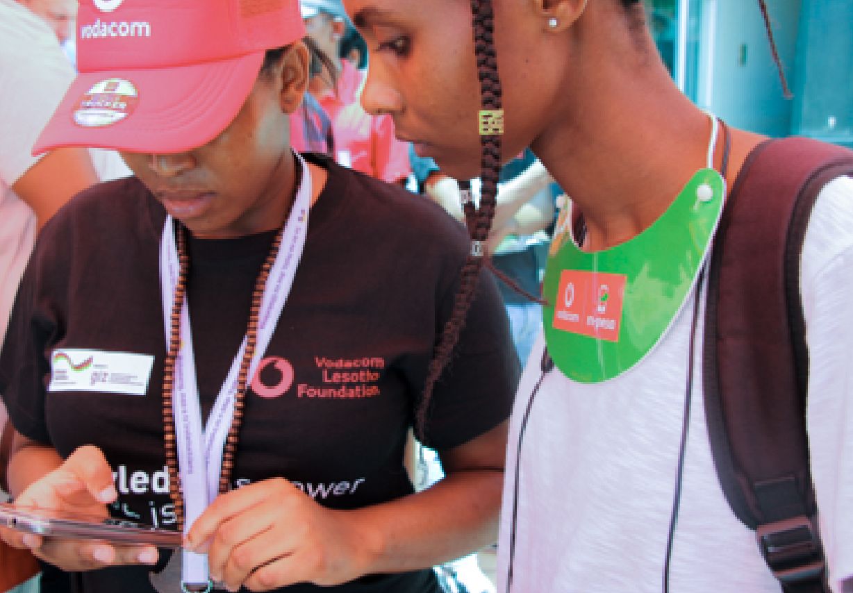 Photo: Two women looking at a smartphone together.