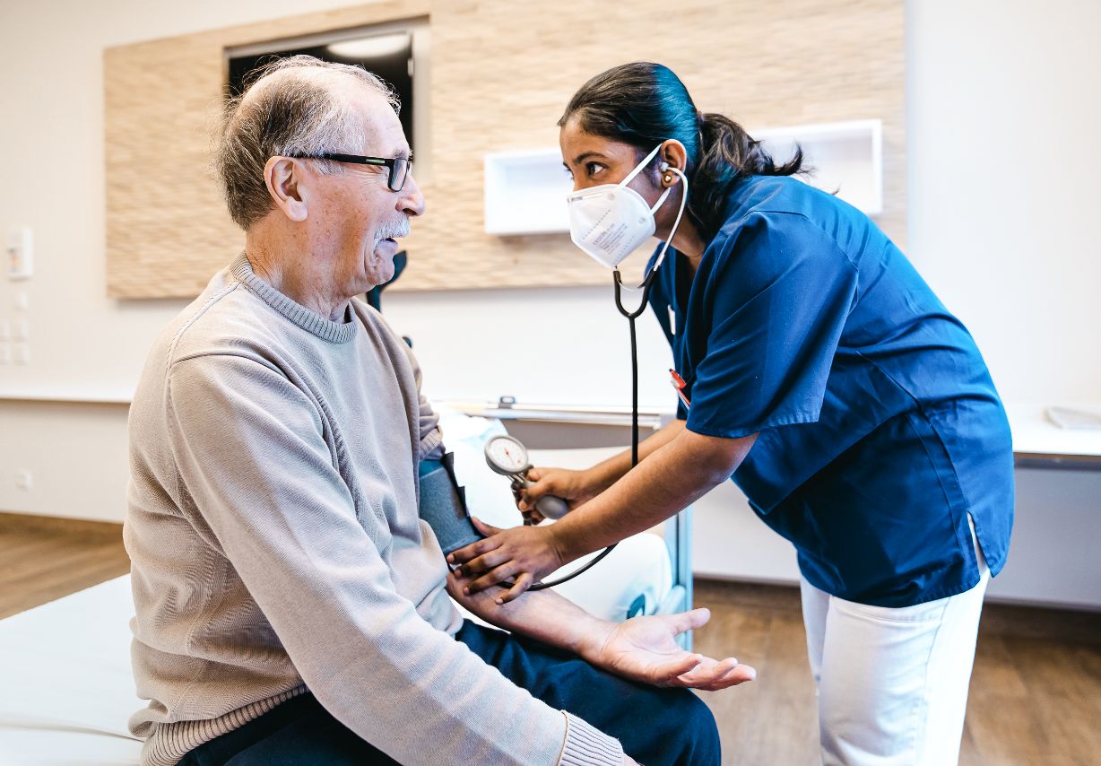 Photo: A nurse taking a patient’s blood pressure. &copy; GIZ, Photo: Tristan Vostry