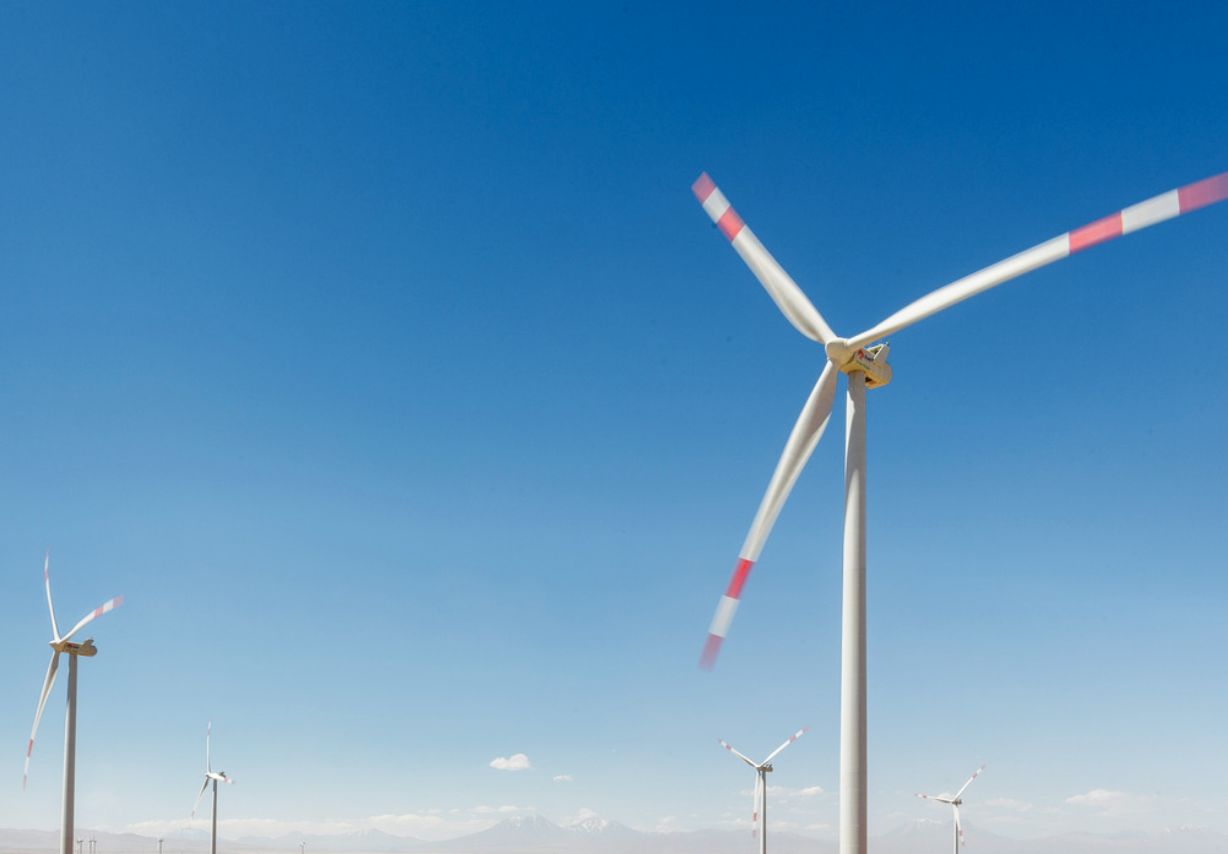 Photo: Windmills against a blue sky.