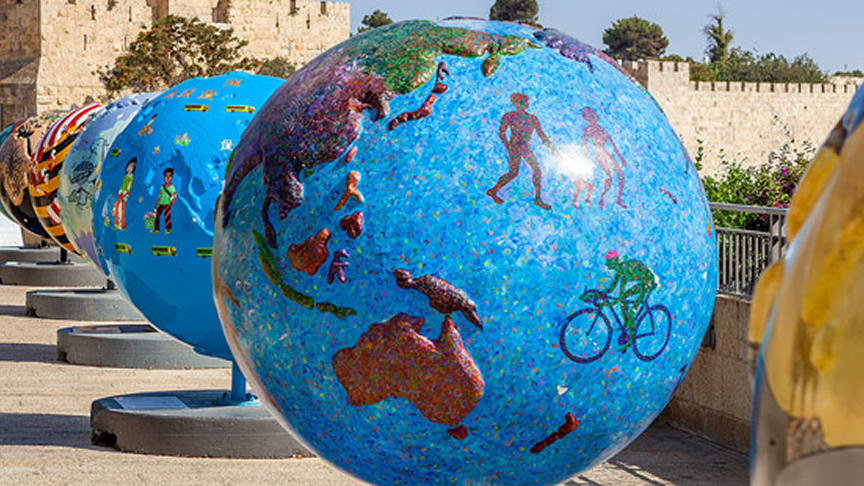 Photo: A row of globes painted in bright colours.